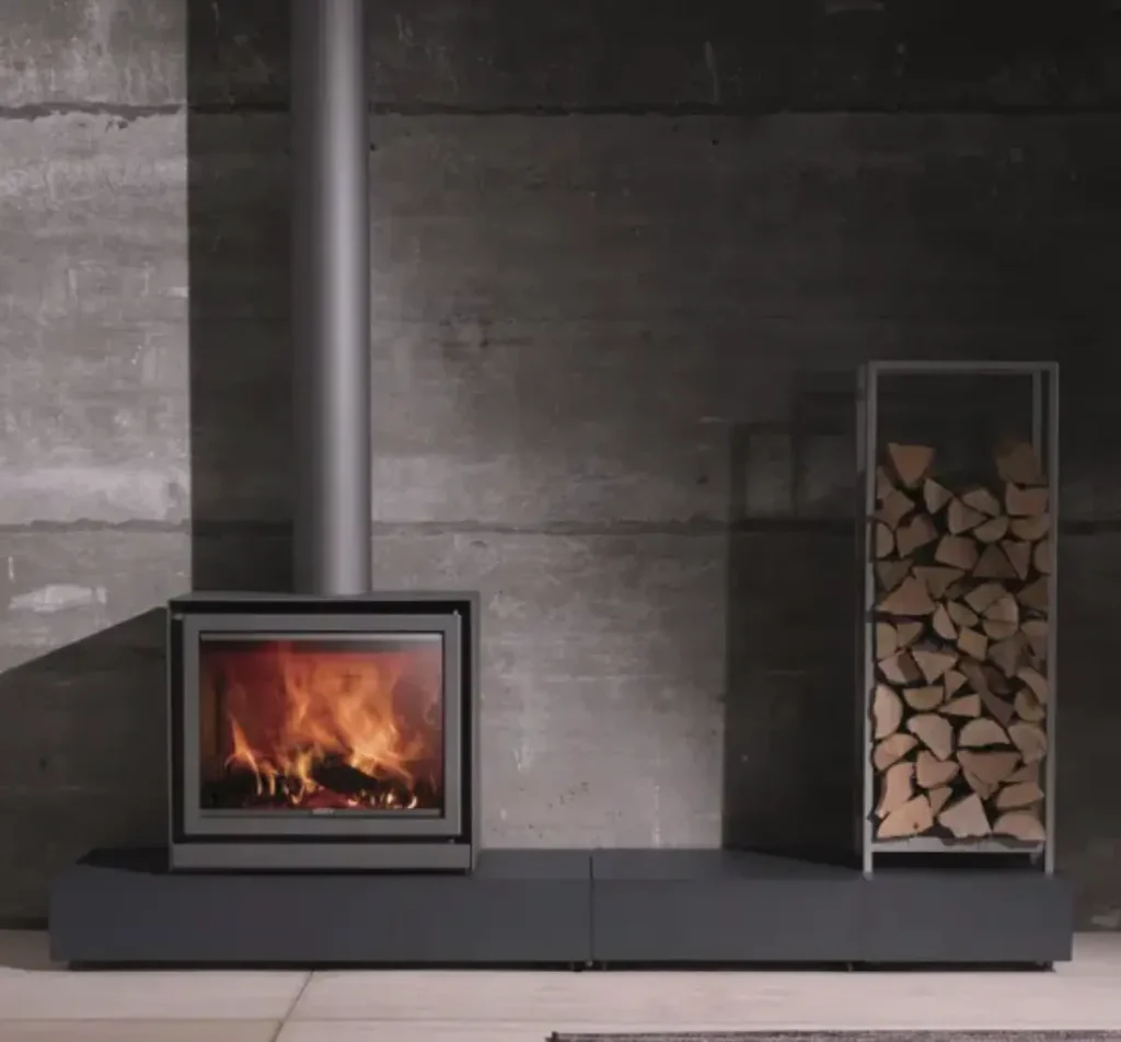 A Stuv 16 with a stack of wood. A great fireplace for increasing a home's value.